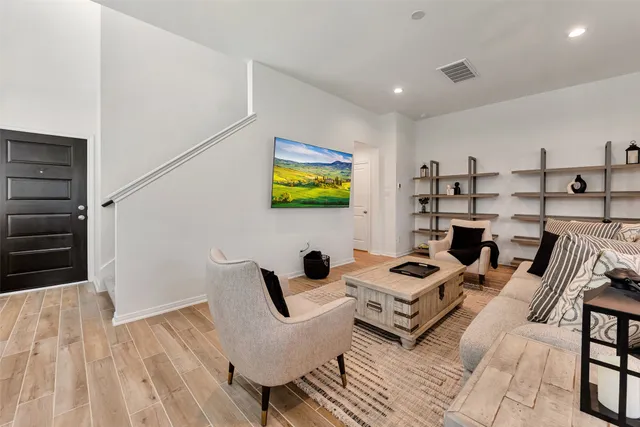 a living room with furniture and wooden floor