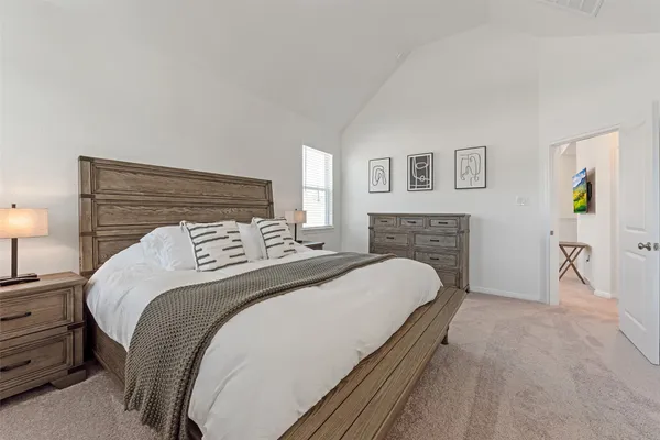 a bedroom with a bed and a couch