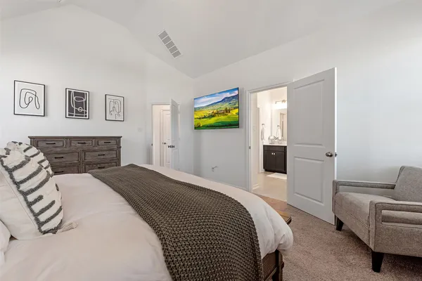 a bedroom with a bed and a couch