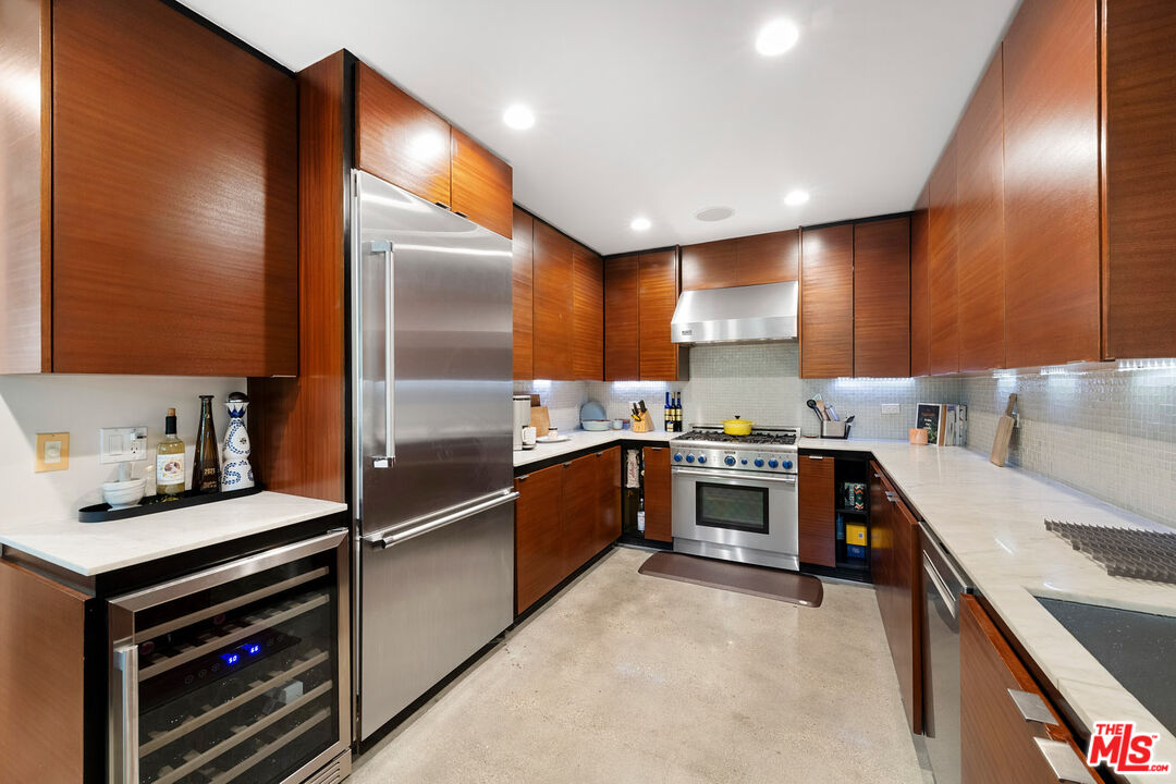417 Venice Way Venice, CA 90291 - Photo 11 of 53 a large kitchen with stainless steel appliances kitchen island granite countertop a refrigerator and a stove top oven