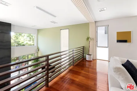 a view of a room with wooden floor and furniture