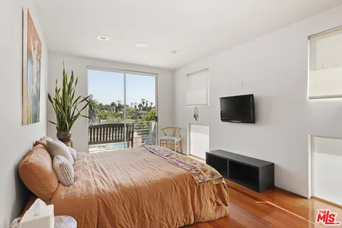 a bedroom with a bed and a television