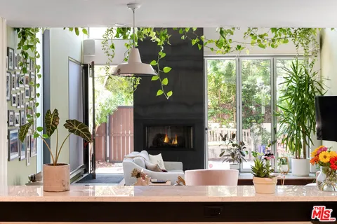 a view of a dining room with a floor to ceiling window and a fireplace