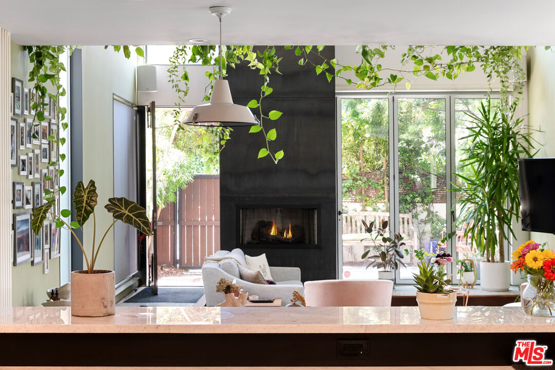417 Venice Way Venice, CA 90291 - Photo 2 of 53 a view of a dining room with a floor to ceiling window and a fireplace