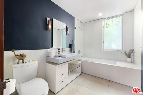 a bathroom with a toilet sink and bathtub