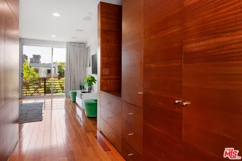 a view of hallway with wooden floor