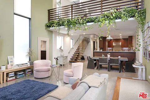 a living room with furniture and a potted plant