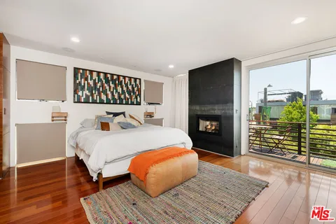 a bed room with a bed and a fireplace