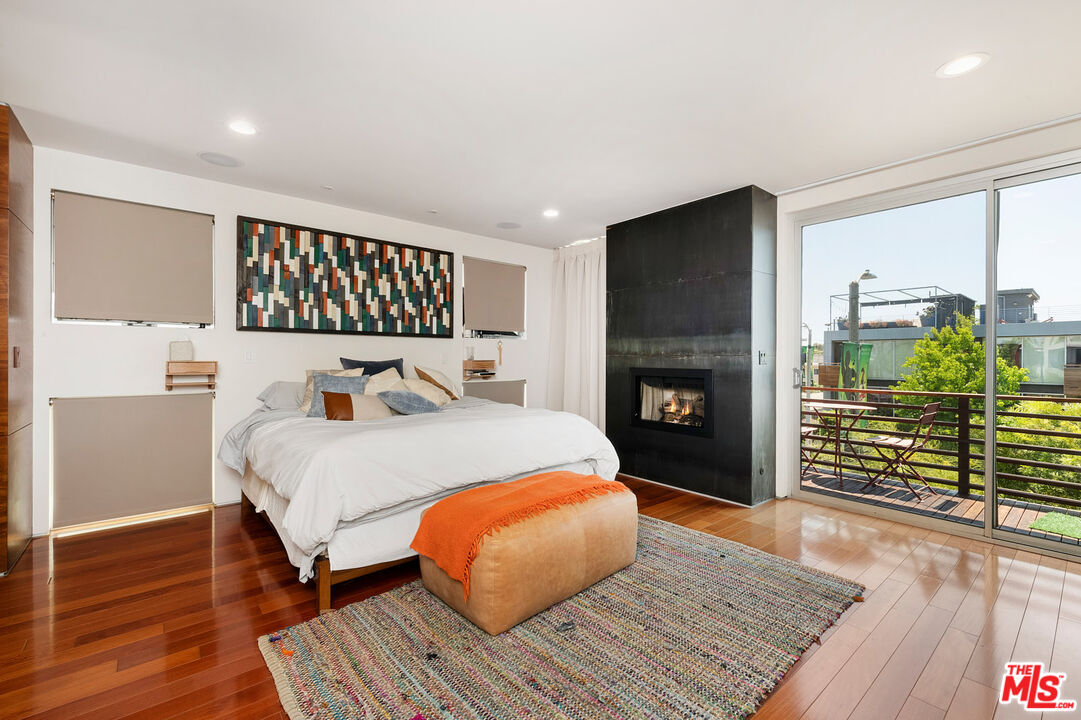 417 Venice Way Venice, CA 90291 - Photo 32 of 53 a bed room with a bed and a fireplace