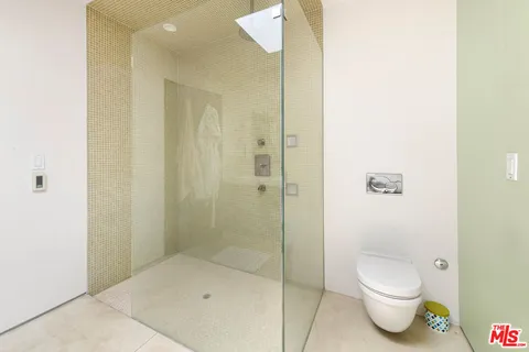 a bathroom with a toilet and shower