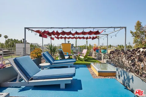 a view of a chairs and table in backyard