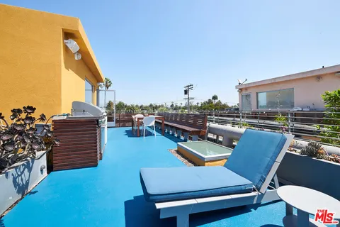 a balcony view with a seating space