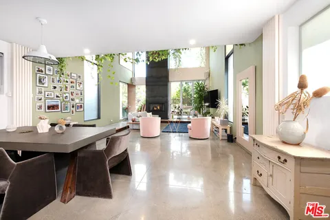 a view of a dining room with furniture and a potted plant