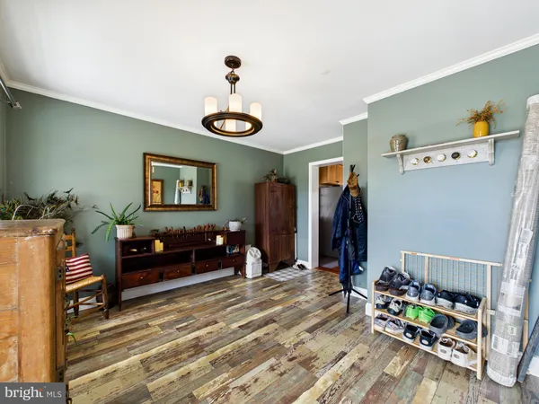 a bathroom with a granite countertop sink toilet a large mirror and a window