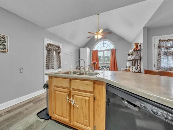 a view of a kitchen counter space and wooden floor