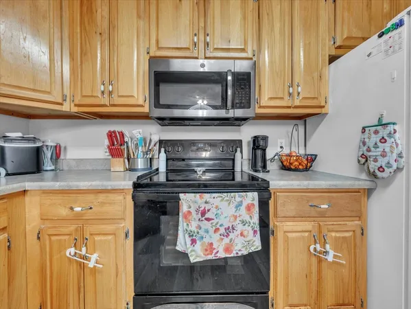 a kitchen with stainless steel appliances granite countertop a stove and a microwave