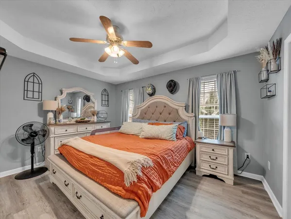 a bedroom with a bed and wooden floor