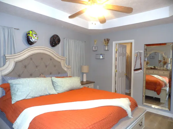 a bedroom with a bed and a chandelier