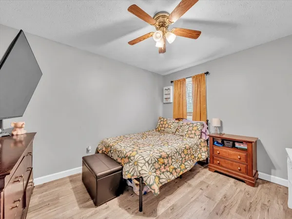 a bedroom with a bed and a ceiling fan