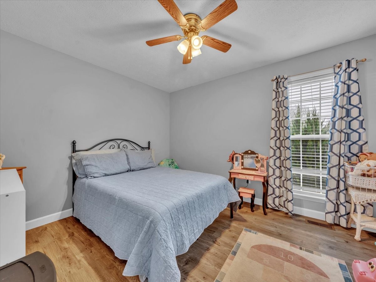 9 Merideth Lynn Road Fayetteville, TN 37334 - Photo 23 of 31 a bedroom with a bed and a chandelier