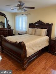 a large bed sitting in a bedroom next to a window with dresser and mirror