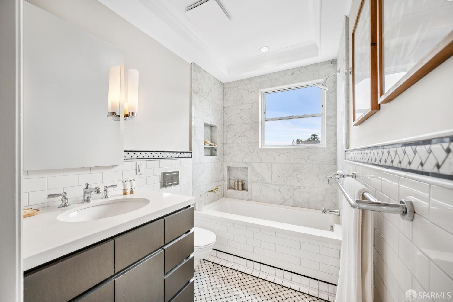 639 14th Street San Francisco, CA 94114 - Photo 24 of 54 a bathroom with a tub sink and mirror