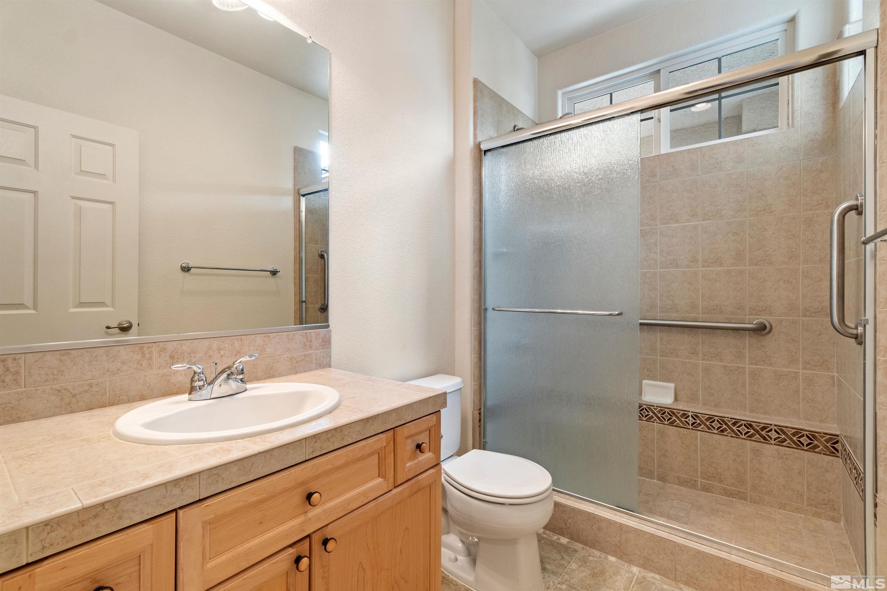 1790 Camaraderie Way Reno, NV 89521 - Photo 29 of 40 a bathroom with a granite countertop sink toilet and shower