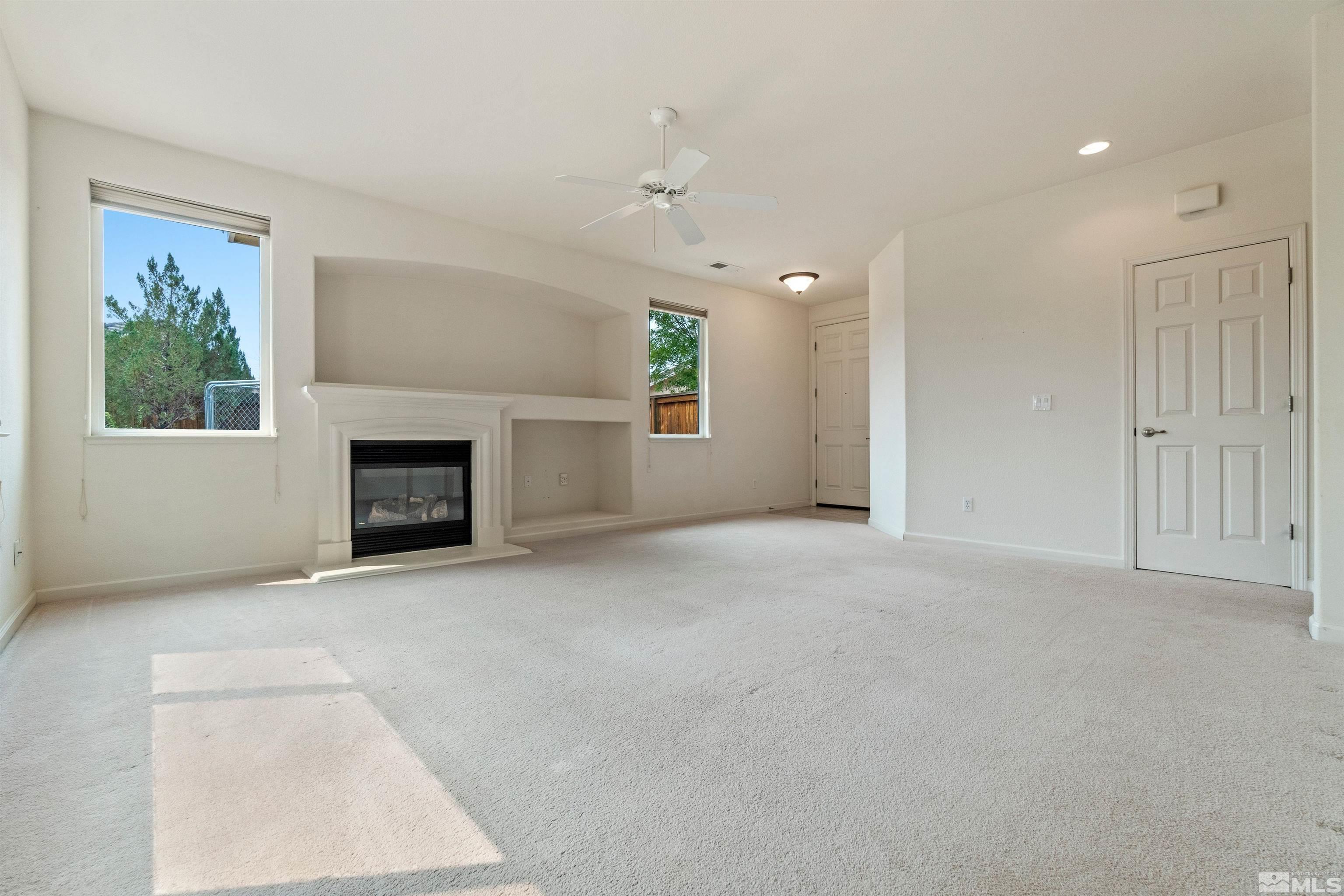 1790 Camaraderie Way Reno, NV 89521 - Photo 7 of 40 an empty room with windows and fireplace