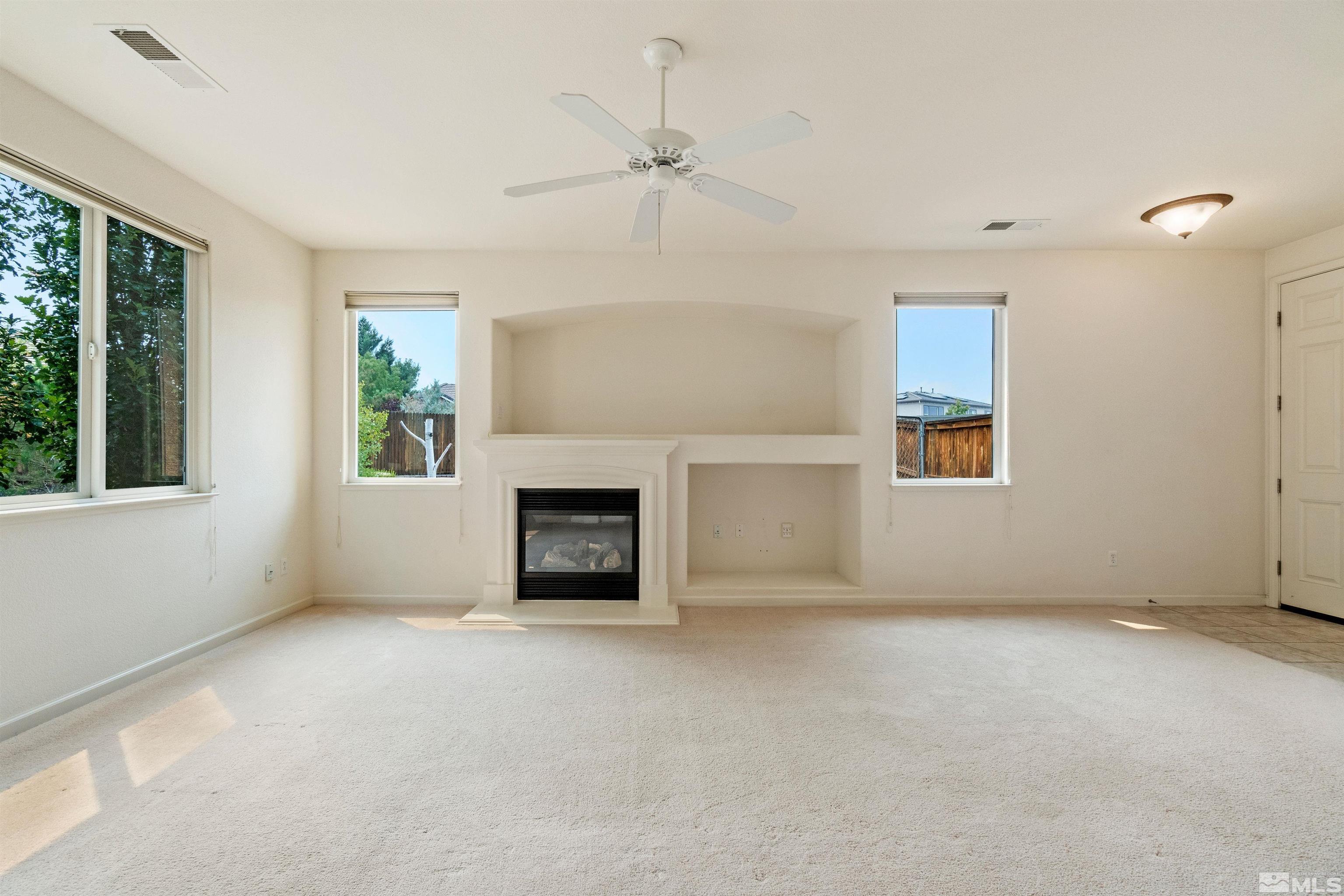 1790 Camaraderie Way Reno, NV 89521 - Photo 9 of 40 an empty room with windows and fireplace