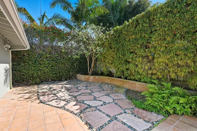 a view of a hallway with wooden floor and a kitchen