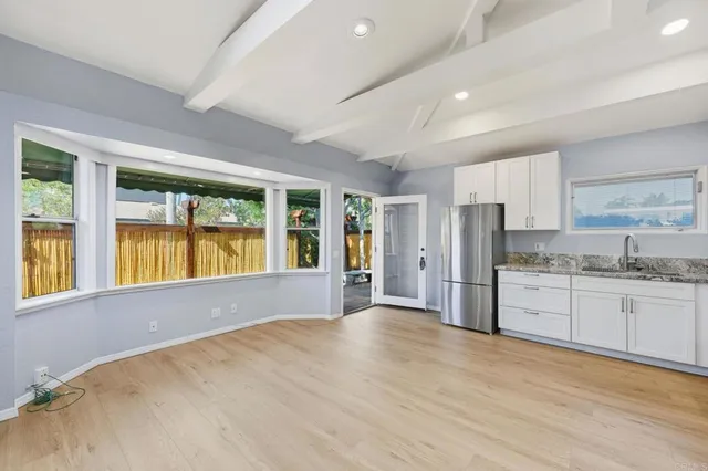 a view of kitchen with cabinets and wooden floor