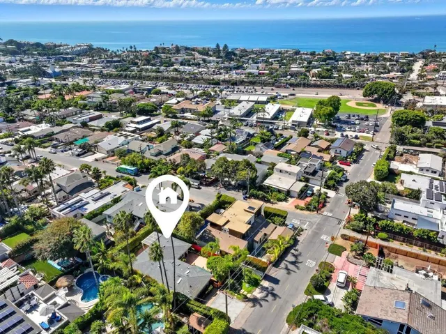 an aerial view of multiple houses with yard