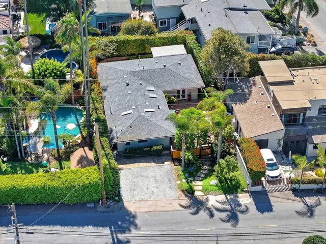 an aerial view of houses with outdoor space