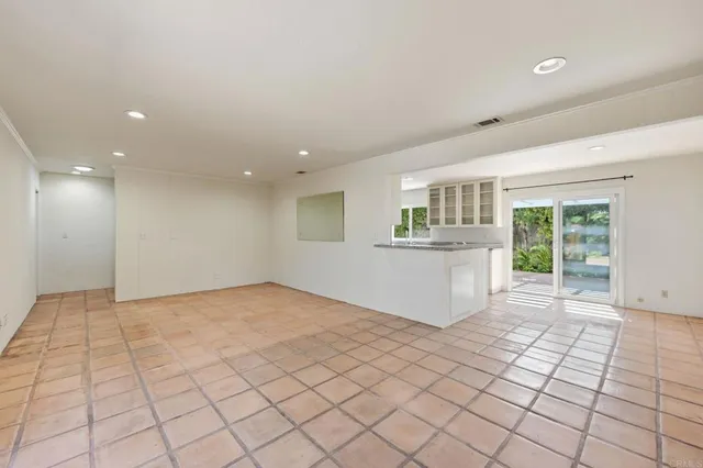 a large kitchen with kitchen island granite countertop a large window and a sink