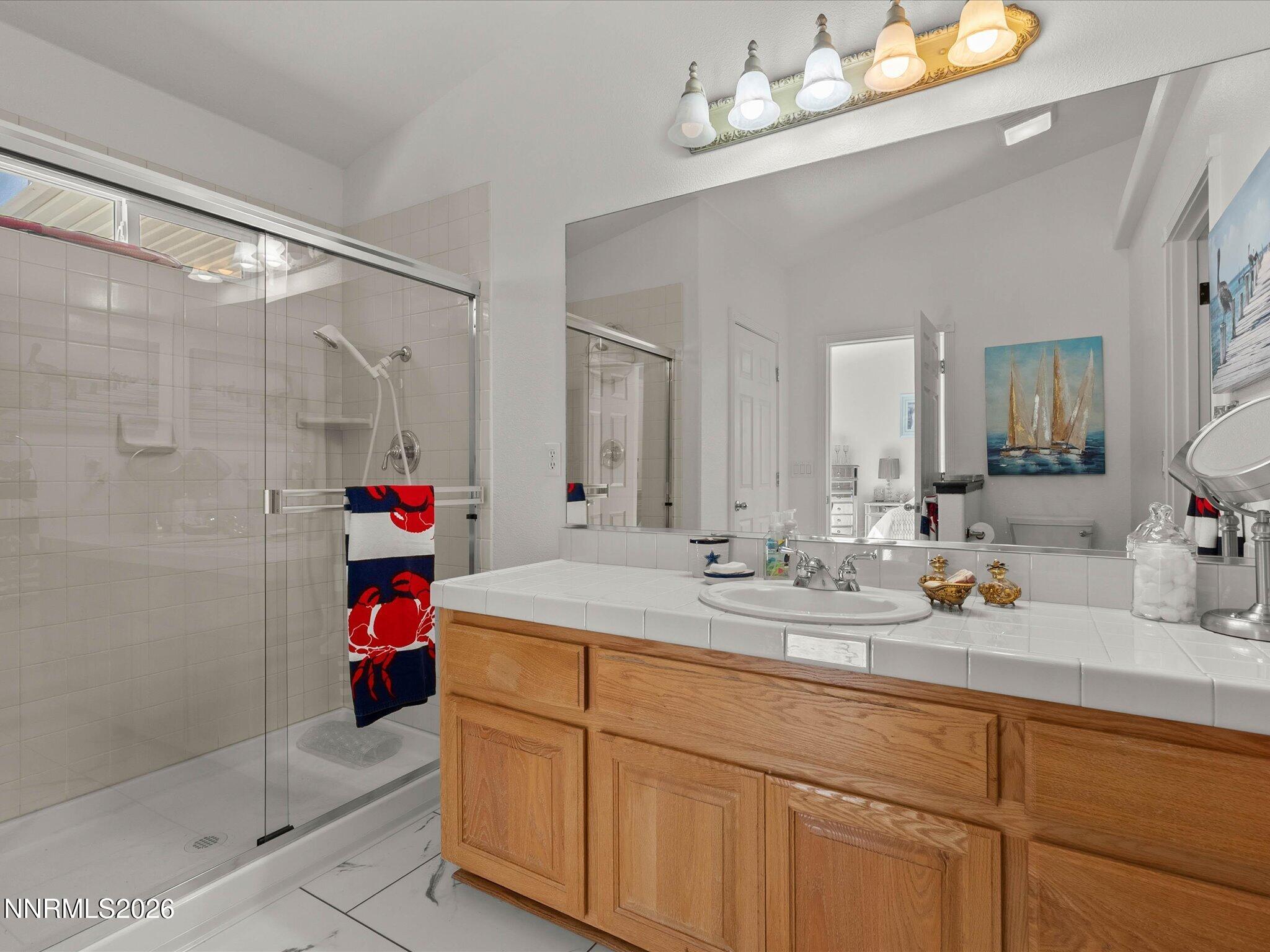 1080 Red Rock Road Fernley, NV 89408 - Photo 23 of 45 a bathroom with a sink vanity and a mirror