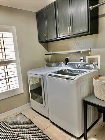 a utility room with a sink washer and dryer