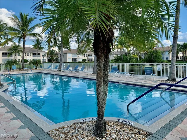 a view of swimming pool with a table and chairs