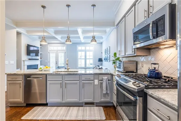 a kitchen with stainless steel appliances granite countertop a stove and a sink