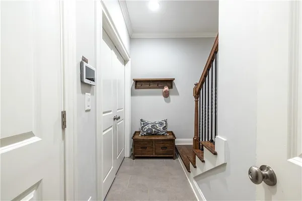 a hallway with sliding door and stairs