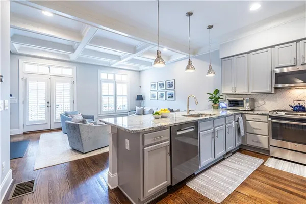 a kitchen with a sink stove and wooden cabinets