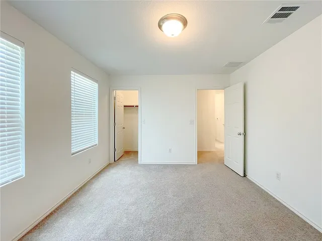 a bathroom with a sink a toilet a light fixture and a mirror