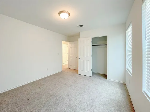 a view of an empty room and a window