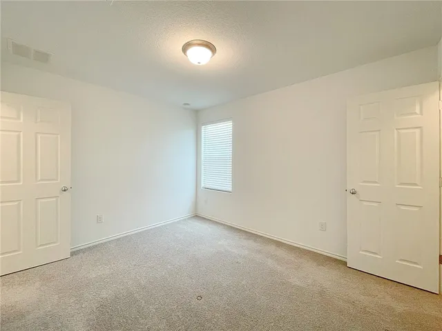 an empty room with a fan