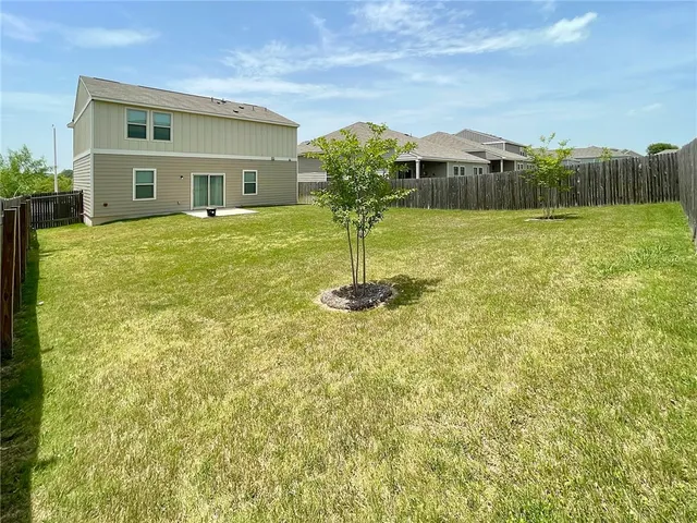 a view of a patio with a table and chairs