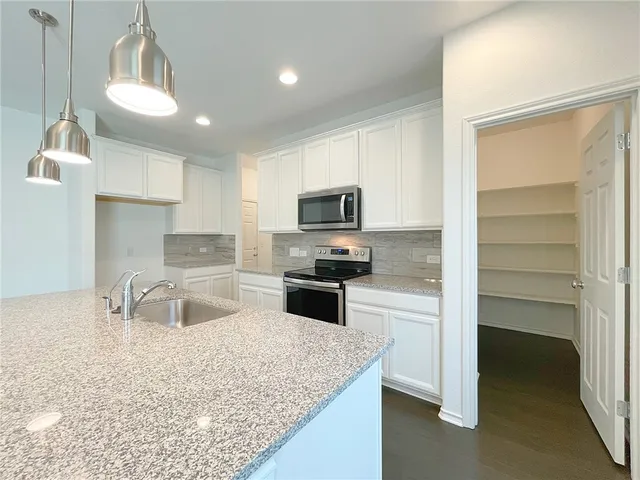 a white toilet sitting next to a bathroom sink