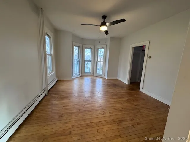 wooden floor in an empty room with a window