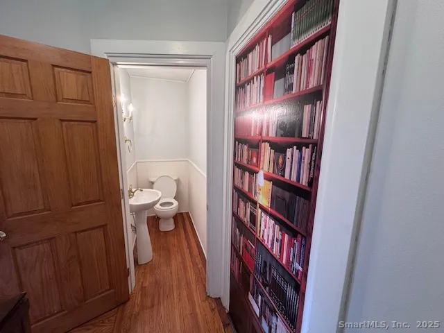 a view of a hallway with wooden floor and entryway