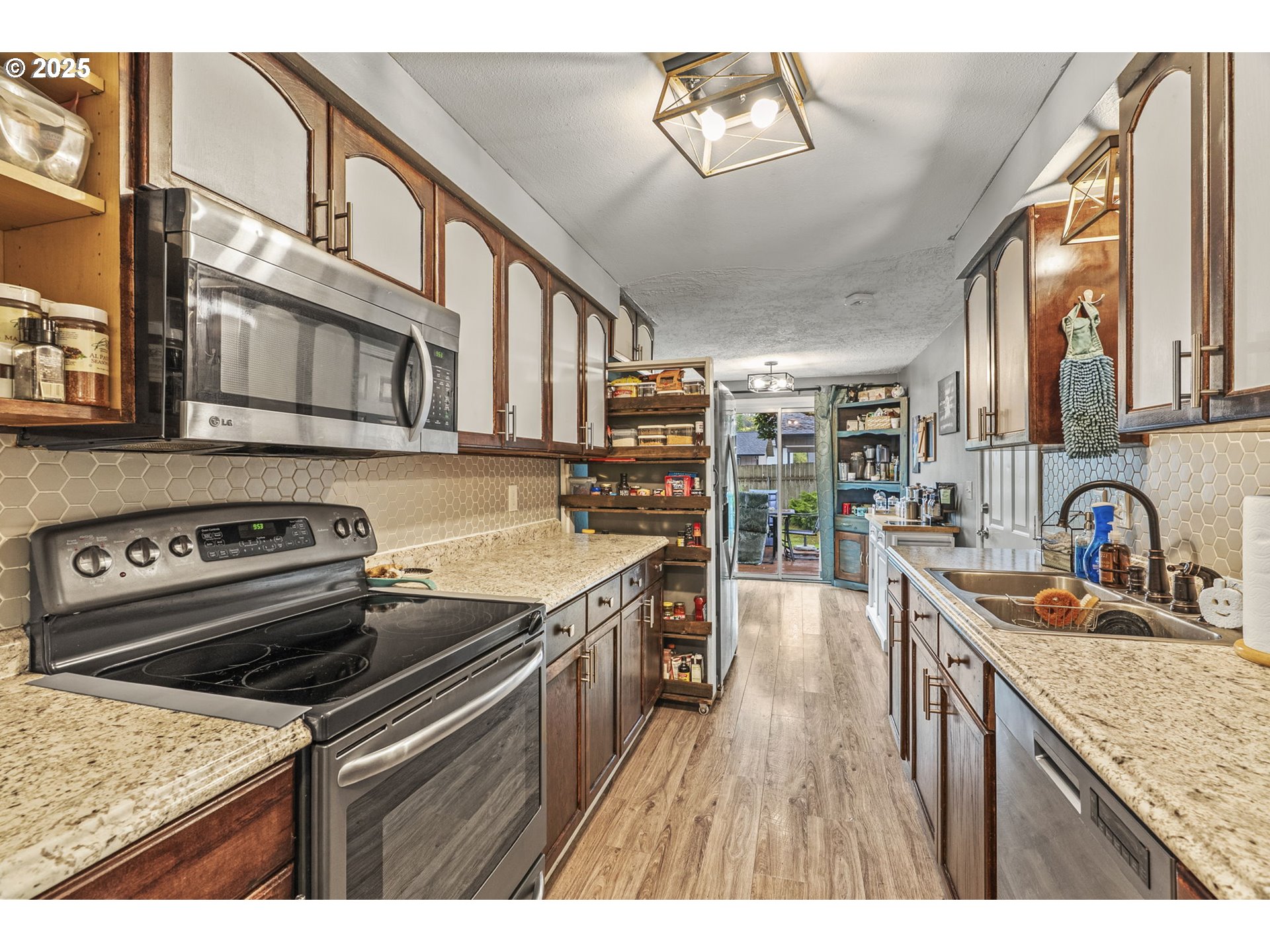 2634 34th Avenue Longview, WA 98632 - Photo 11 of 22 a kitchen with stainless steel appliances granite countertop a stove and a sink