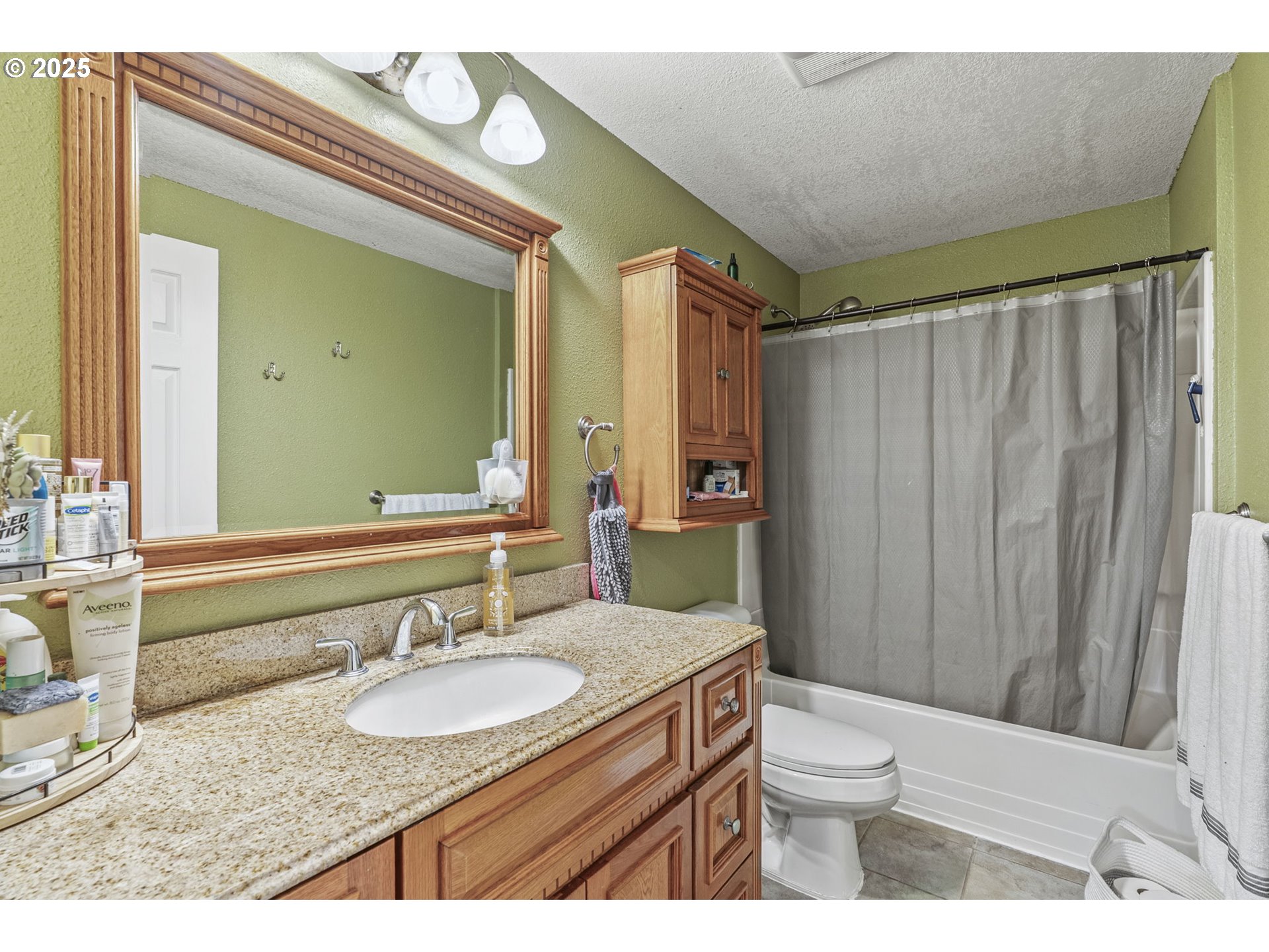 2634 34th Avenue Longview, WA 98632 - Photo 13 of 22 a bathroom with a granite countertop sink toilet and shower