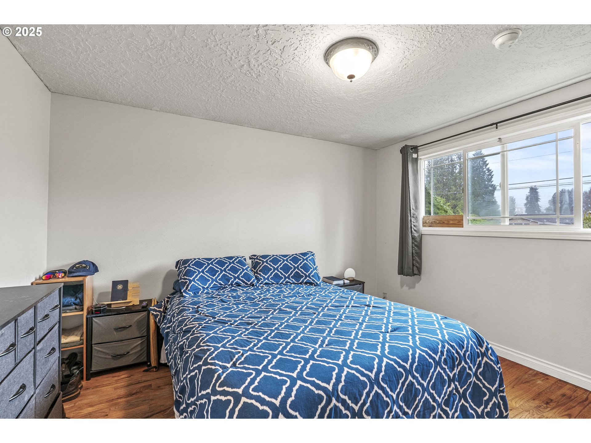 2634 34th Avenue Longview, WA 98632 - Photo 14 of 22 a bedroom with a bed and wooden floor